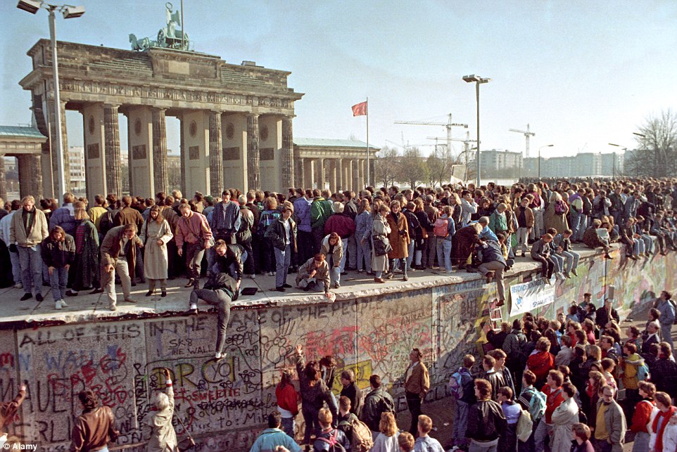 Tearing it down: But more than 25 years since the iconic Berlin Wall, which separated east from west Germany, came down, the effectiveness of these walls as little more than a symbol is being questioned